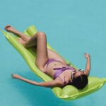 Inflatable Pool Rafts - Relaxed woman lying on air mattress