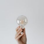 Light Shows - Anonymous female showing light bulb