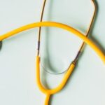 Prevent Algae - Top view of yellow medical stethoscope placed on white surface during coronavirus pandemic