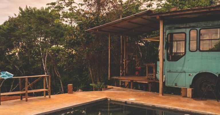 Reopening Pool - A bus parked in front of a pool with a view of the mountains