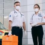 First Aid Kit - Paramedics Standing near an Ambulance