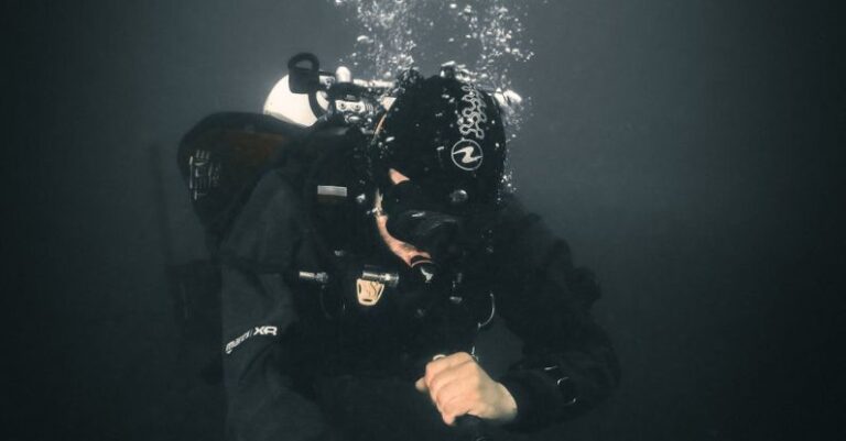 Underwater-Themed Bash - A scuba diver is holding a camera underwater