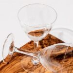 Vintage Beach Party - Thin tall beverage glasses on a wooden cutboard