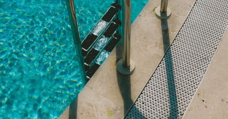 Shock Your Pool - A pool with a metal ladder and a shadow
