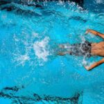 Swimming Workouts - Person Swimming on Body of Water