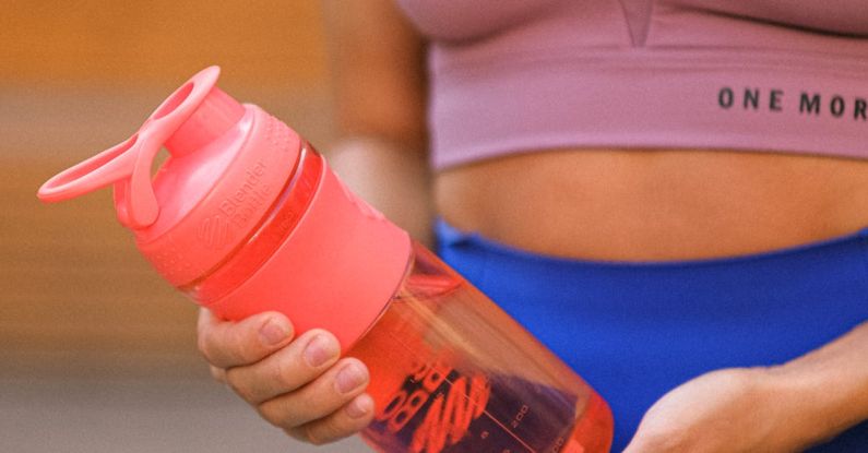 Aqua Aerobics - Crop faceless sportswoman standing with reusable water bottle