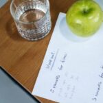 Workout Plan - Green Apple and Glass of Water on the Wooden Table