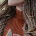 Open Turn Flip Turn - Low angle of positive female with long wavy hair turning page of opened book while reading