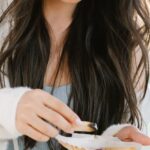 Mental Preparation - Serious Asian woman with palo santo and seashell preparing for spiritual stress relief session