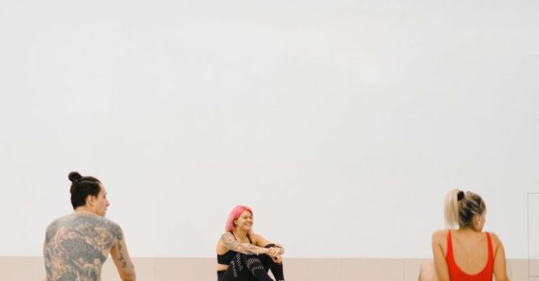 Water Aerobics - People Sitting on Swimming Boards in a Swimming Pool